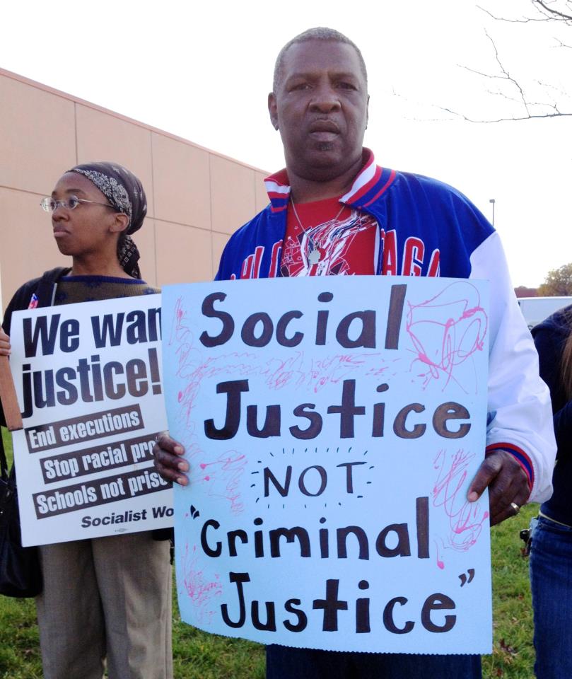 Martel Miller (foreground) and Sophia Lewis stand outside the satellite jail demanding justice