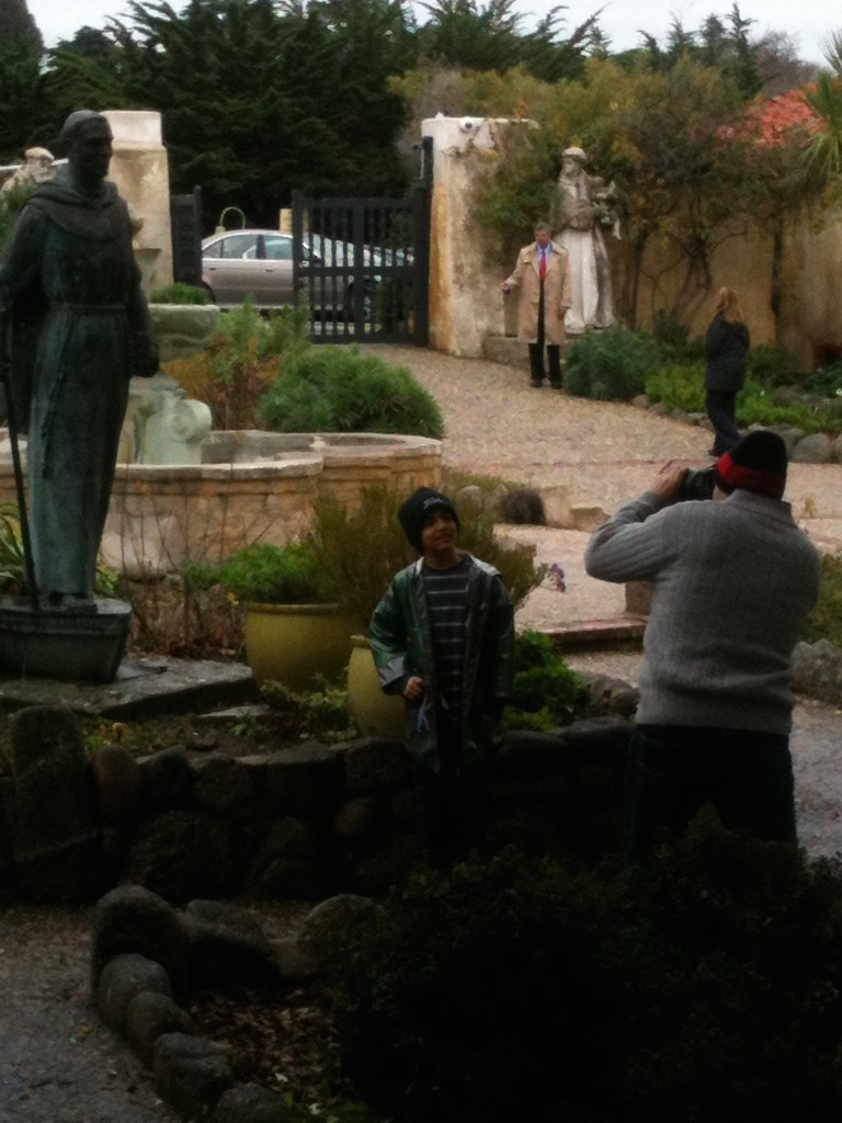 Visitors at the Carmel Mission statue that had been vandalized.