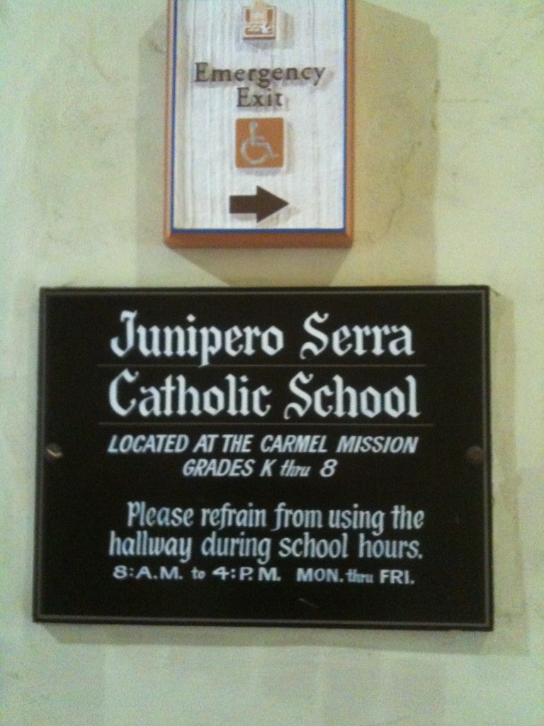 The sign for the active school at Carmel Mission, named after the new Saint.